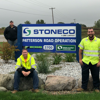 StoneCo employees next to Patterson Road Operation sign