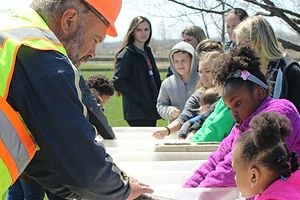 Stoneco employee working with group of children